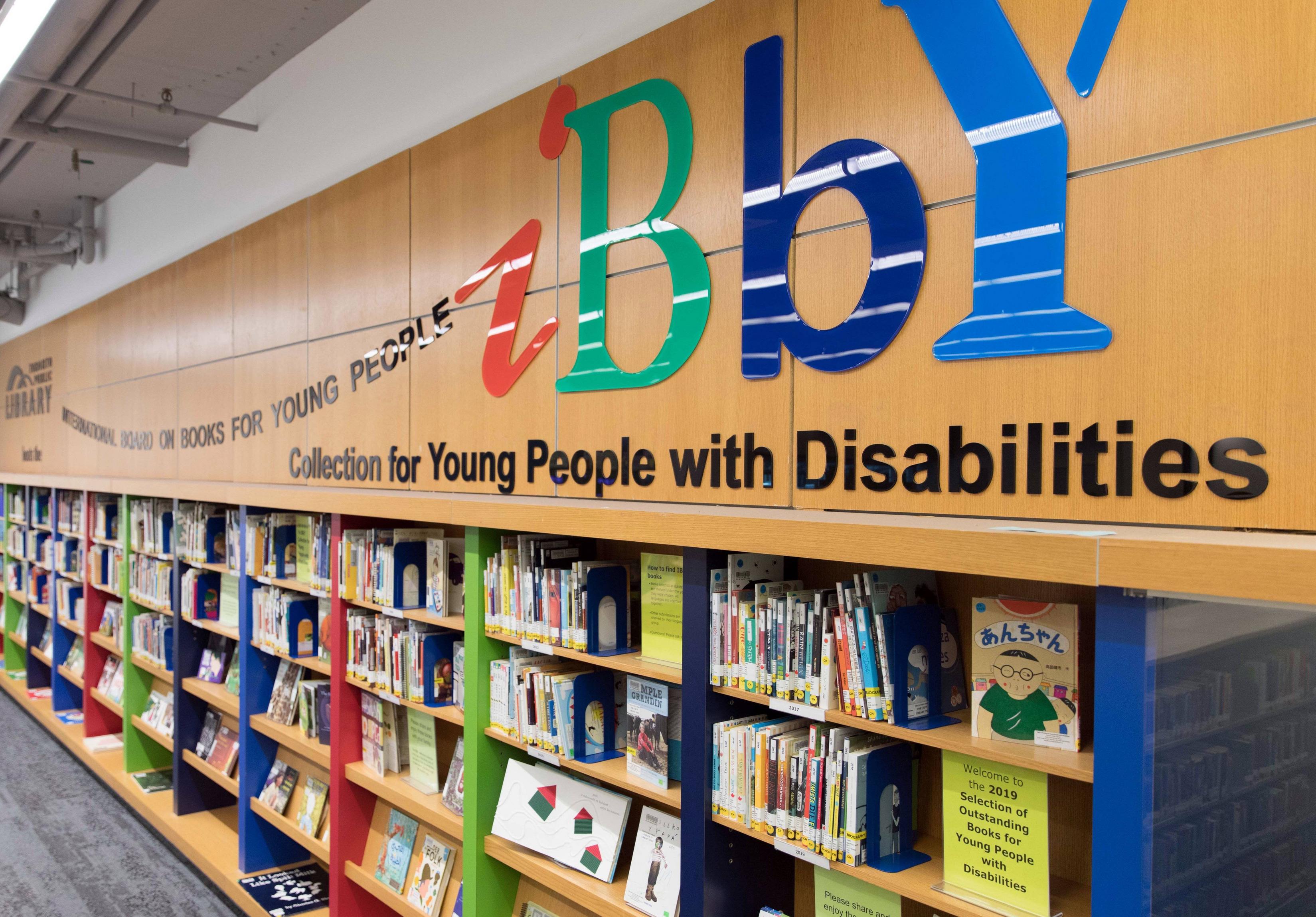 Large shelving with colourful singage for IBBY